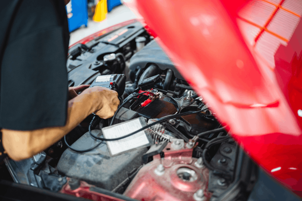 CAN-bus, auto repair in Haslet, TX at Brittni's Automotive Repair. Image of a technician testing a vehicle battery, highlighting accurate diagnostics to ensure reliable starts, proper charging, and prevent unexpected breakdowns.